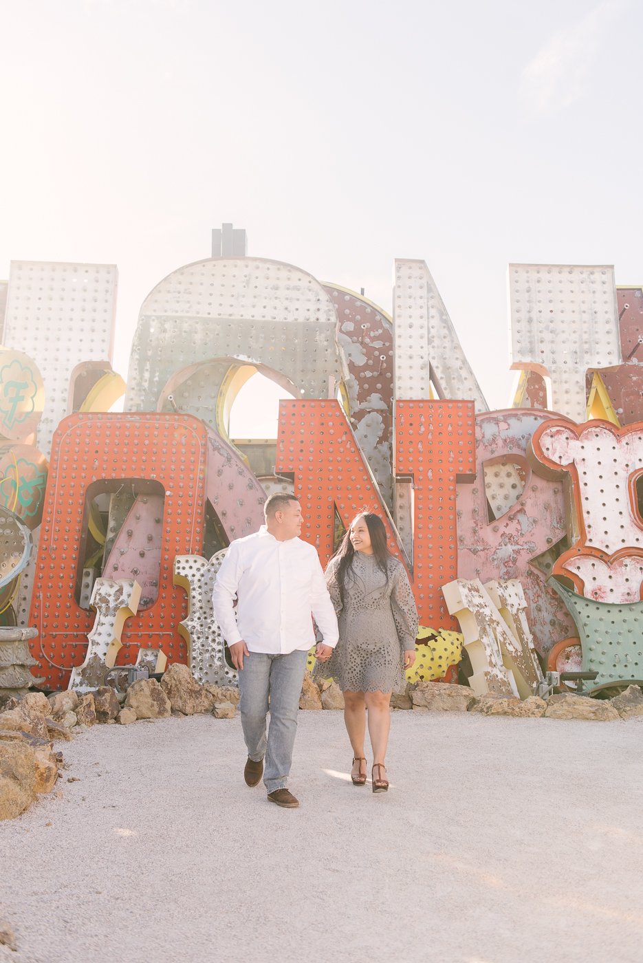 couple walking holding hands at neon museum