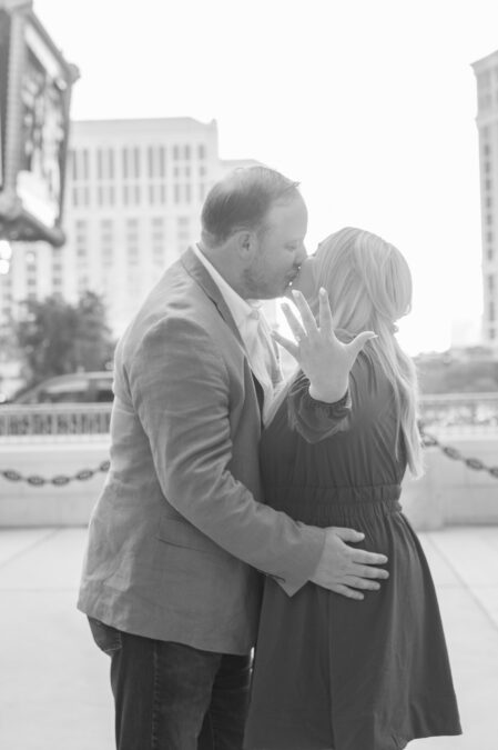 couple showing off ring after proposing in las vegas paris 