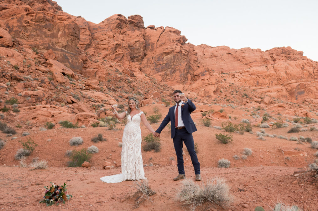 bride and groom celebrating with champagne cheers after ceremony