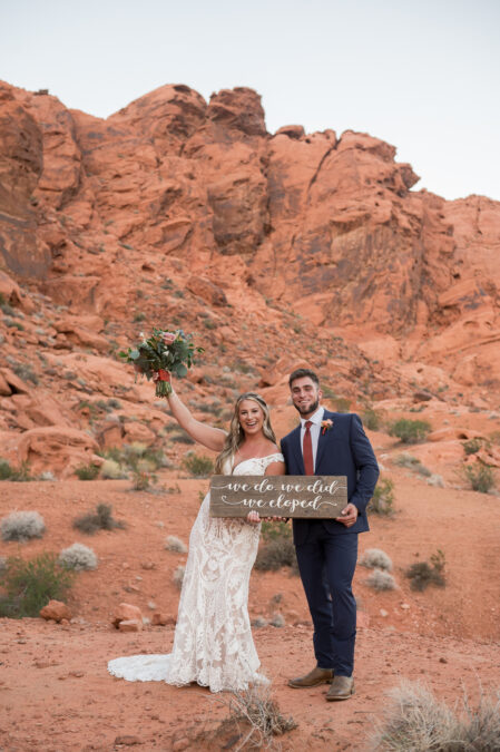 bride hold up we do we did we eloped sign at valley of fire wedding