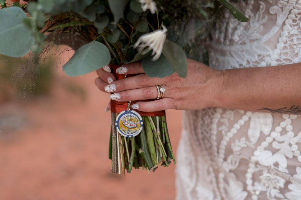 close up of bride's ring and bouquet charm 