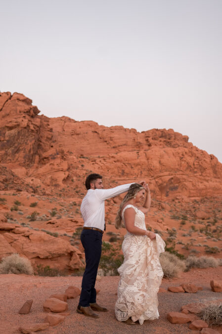 bride and groom dancing at valley of fire during sunset wedding