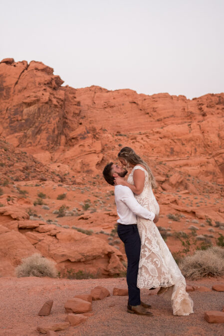 bride and groom dancing at valley of fire during sunset wedding