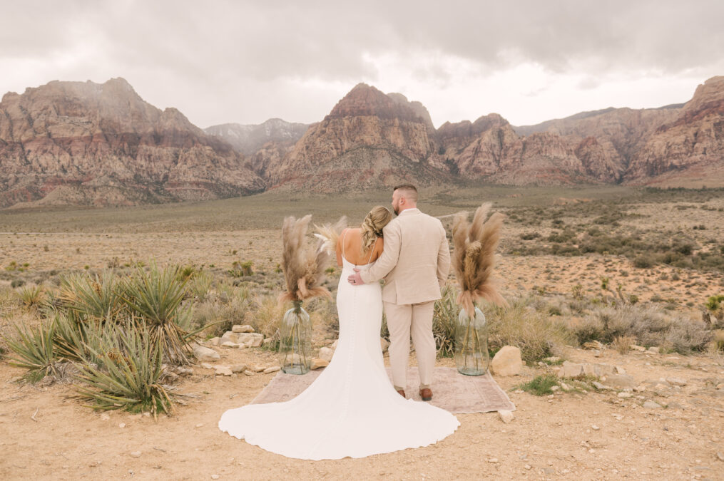 pretty bride and groom portrait with the gorgeous red rock canyon desert mountains in the background