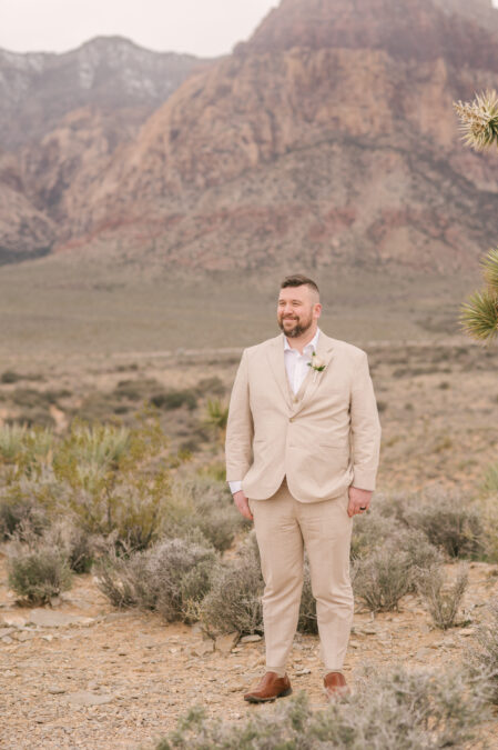 daper groom in beige suite at red rock canyon