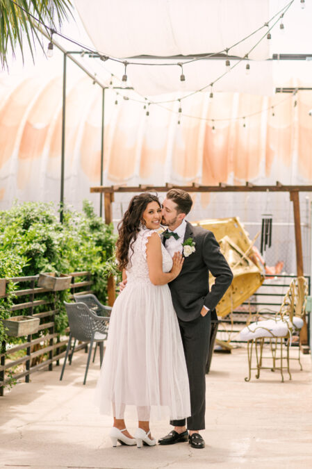 groom kissing smiling bride at their doyle las vegas wedding