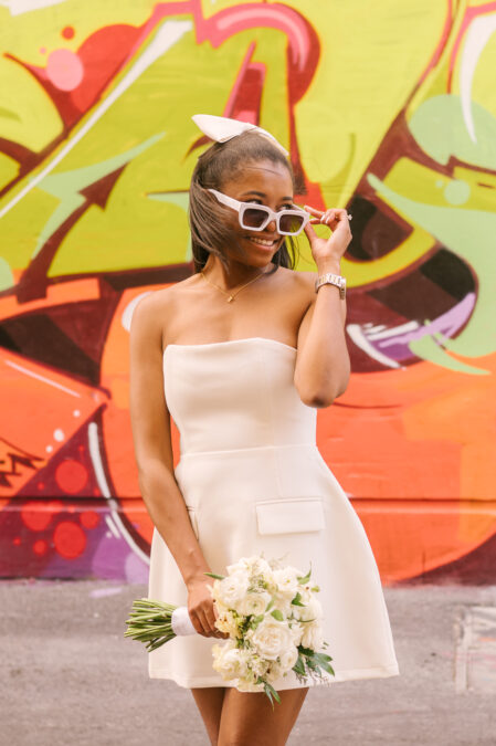cute bride with white sunglasses and short wedding dress