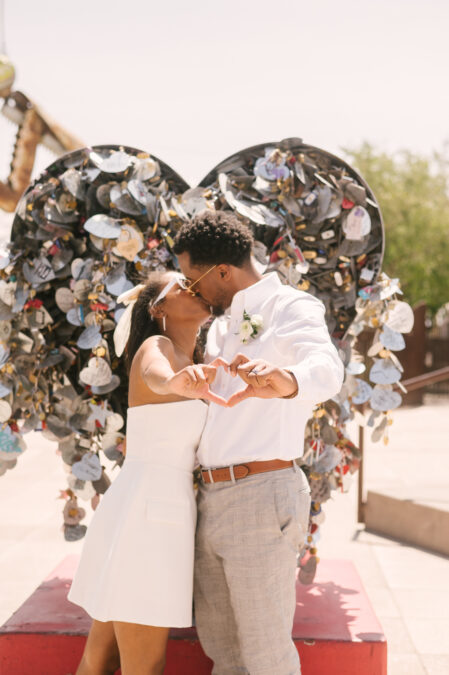 bride and groom kiss in downtown las vegas heart locks