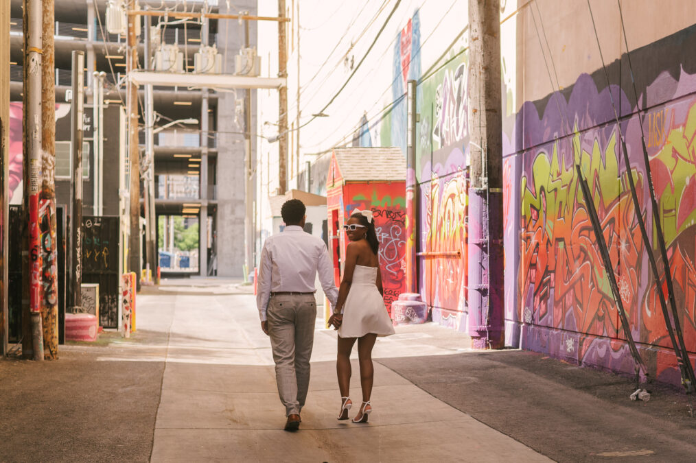 bride and groom walking along graffiti alley in downtown las vegas