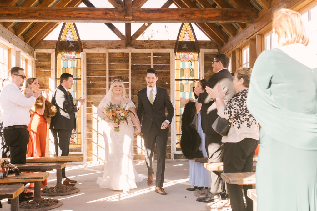 Bride and Groom walking down the aisle in nelson ghost town chapel