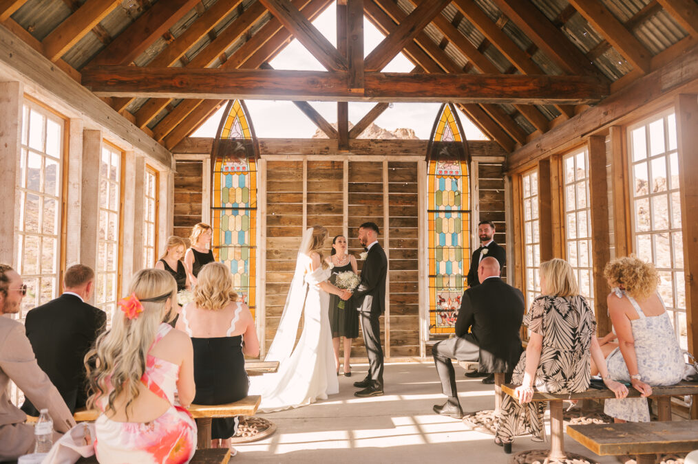 las vegas desert wedding ceremony in wooden chapel with stained glass windows