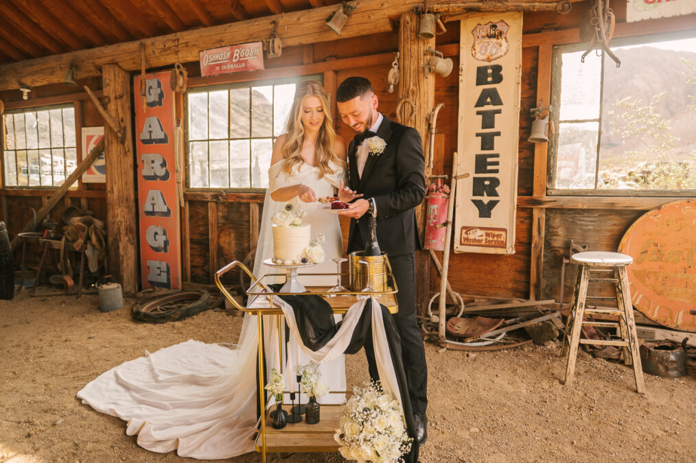 bride and groom cake cutting in a nevada desert barn 
