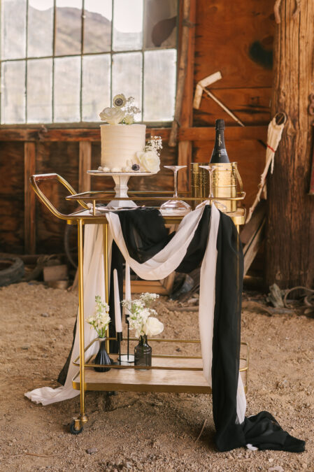 close up of mini cake and champagne set up for desert micro wedding