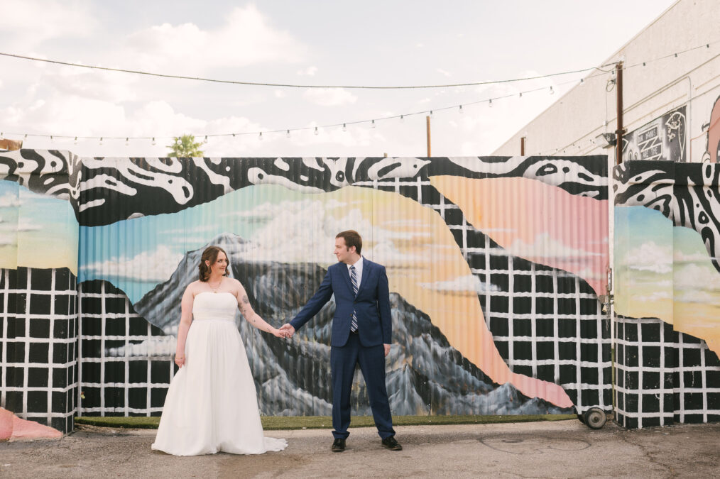 downtown las vegas bride and groom in front of mural 