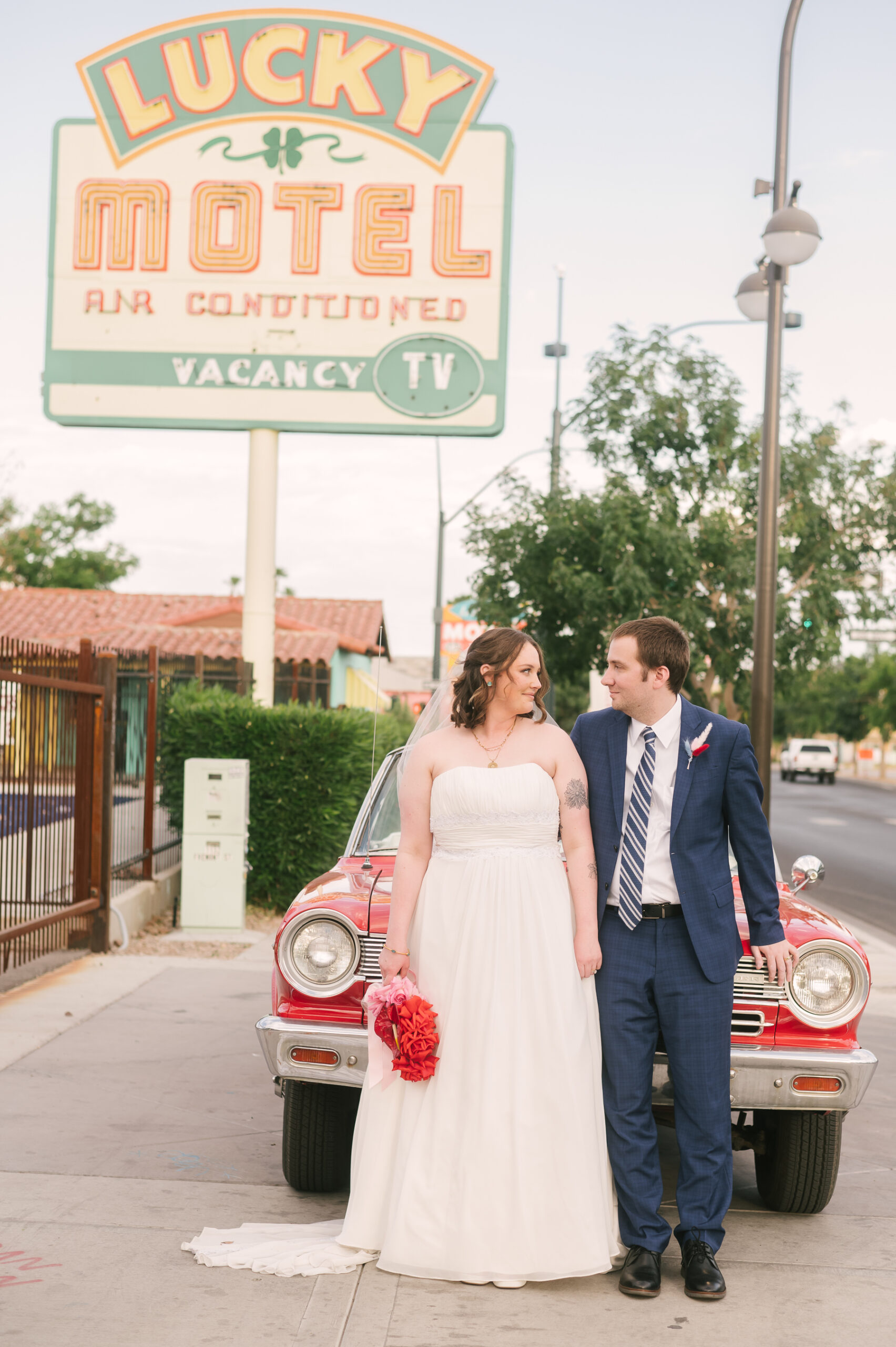 downtown las vegas bride and groom with red vintage car
