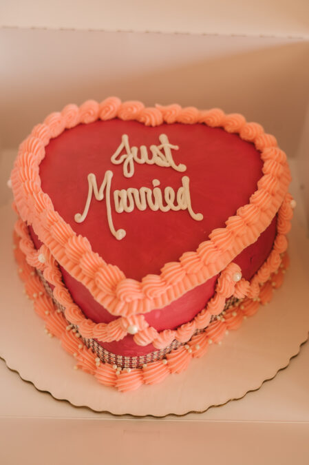 red and pink just married heart-shaped cake