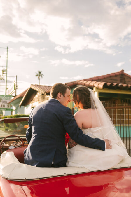downtown las vegas bride and groom in red vintage car from sure thing chapel