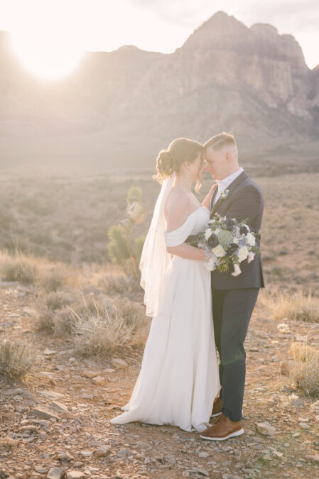 romantic bride and groom portraits with red rock canyon in the background
