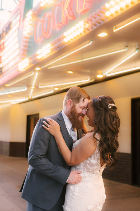 bride and groom snuggling in front of El Cortez casino on Fremont Street Las Vegas