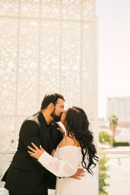 downtown las vegas engagement session with couple kissing 