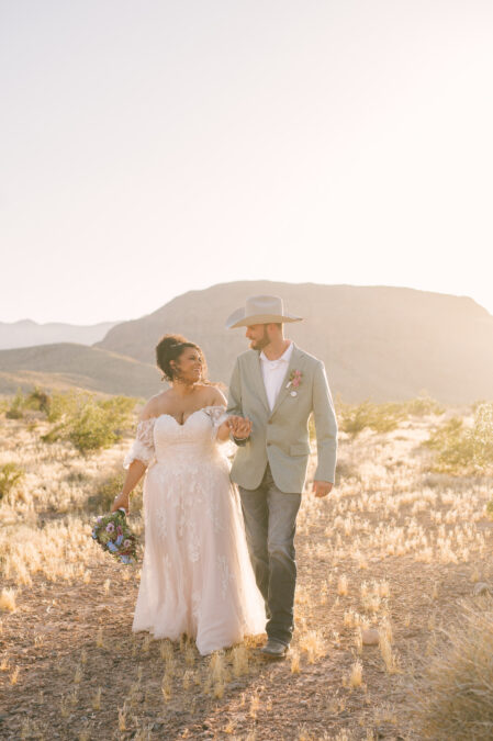 bride and groom walking in desert outside of cactus joes nursery in las vegas - favorite wedding vendors in Las Vegas