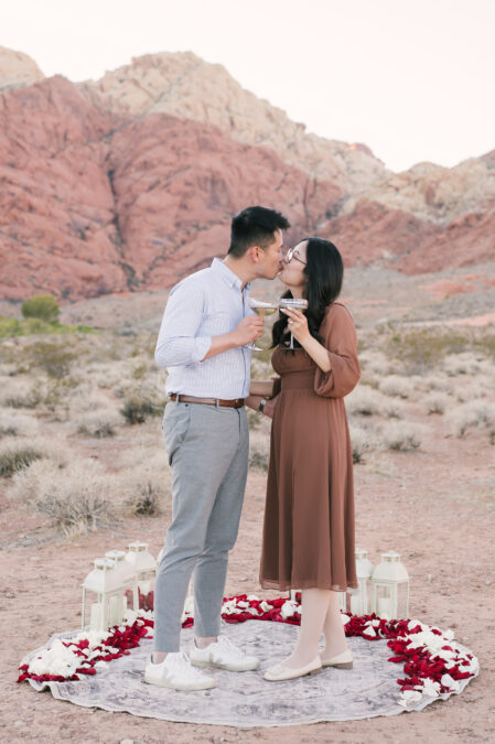 red rock canyon las vegas proposal couple celebrating with champagne
