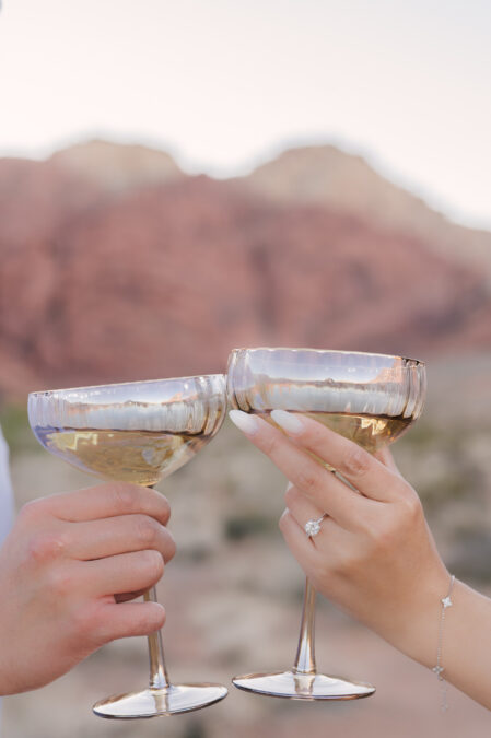 las vegas red rock canyon engagement session focus on ring with champagne glasses