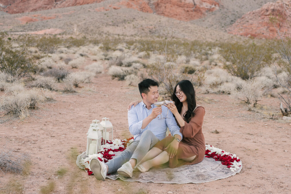 red rock canyon las vegas proposal couple celebrating with champagne