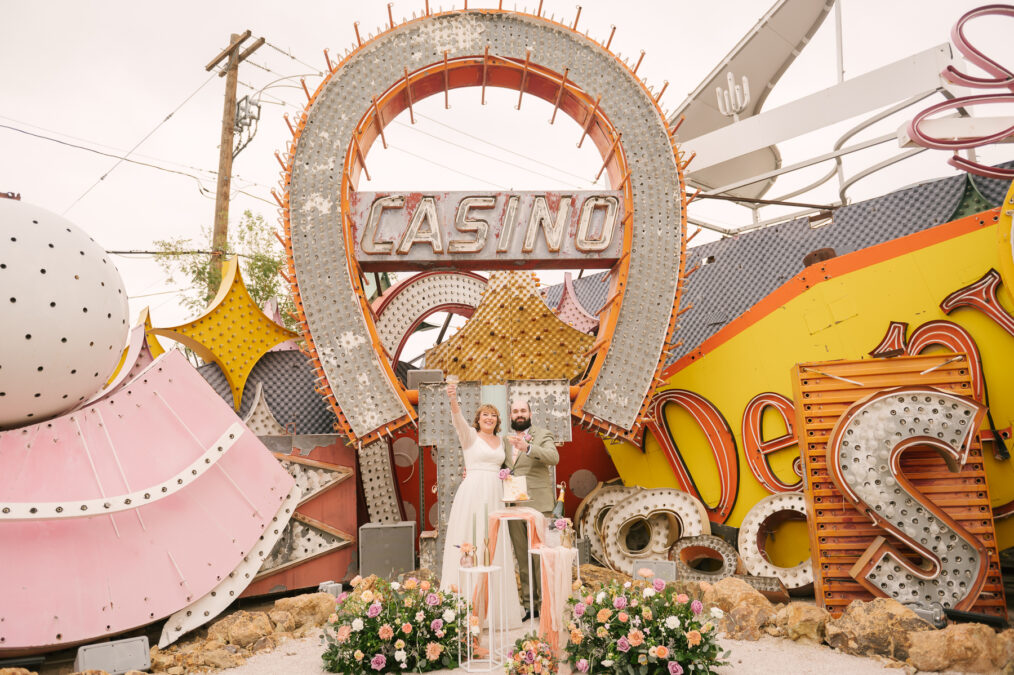 newlyweds toasting after wedding at neon museum las vegas