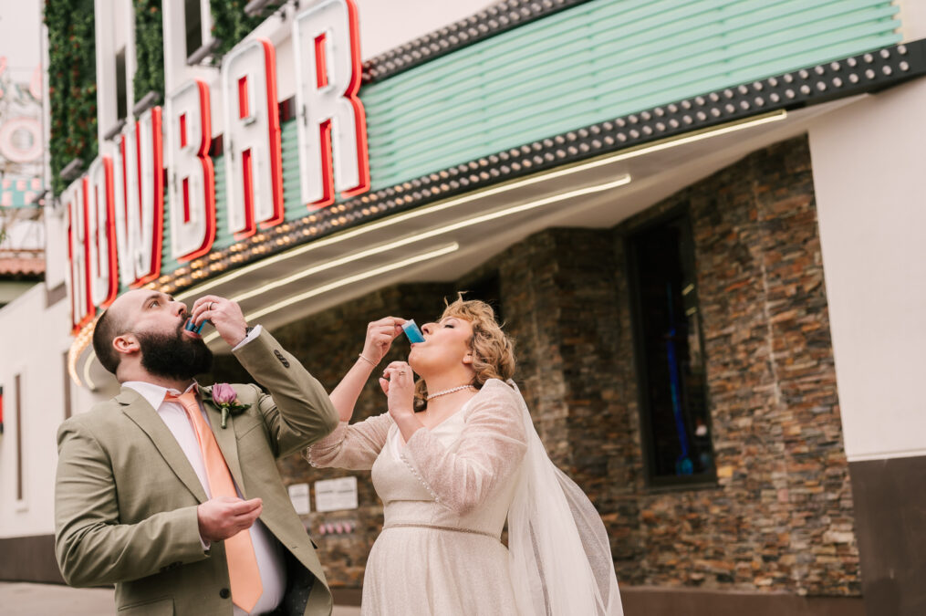 bride and groom doing jello shots on fremont st in downtown las vegas
