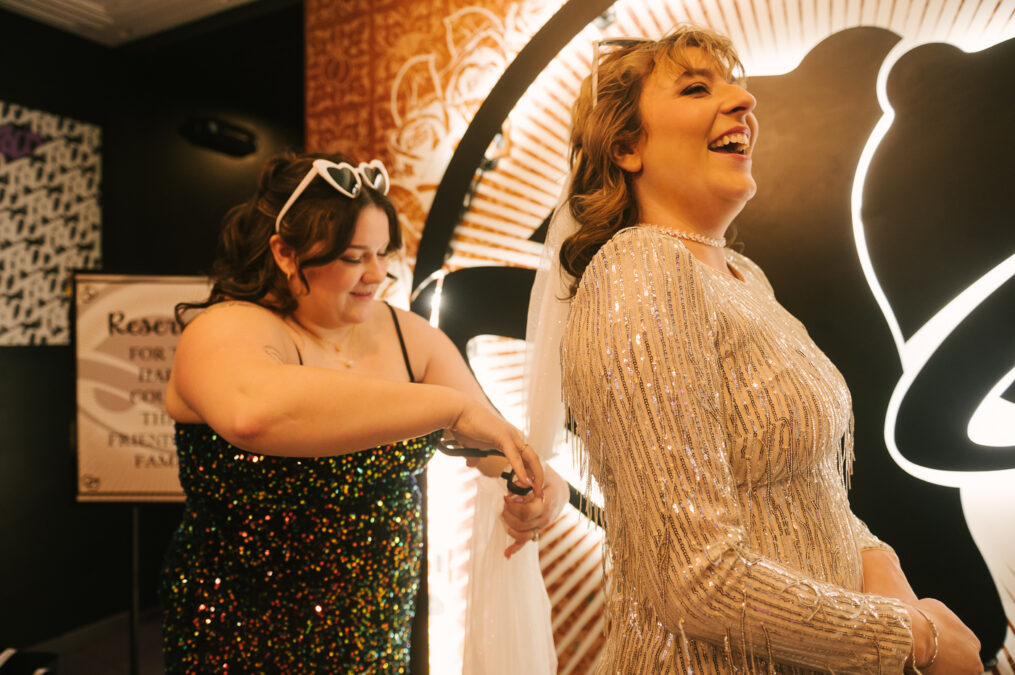 friend cutting veil of bride in las vegas wedding