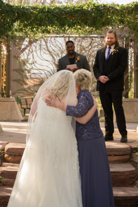 bride walking down aisle with mom at springs preserve ceremony