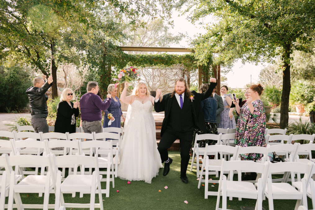 springs preserve bride and groom dancing down the aisle 