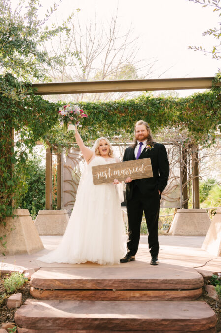 bride and groom with just married sign at springs preserve wedding