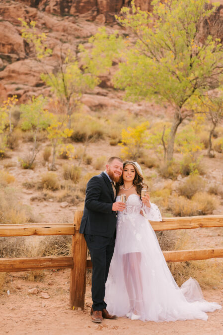 fall elopement bride and groom toasting at red rock canyon