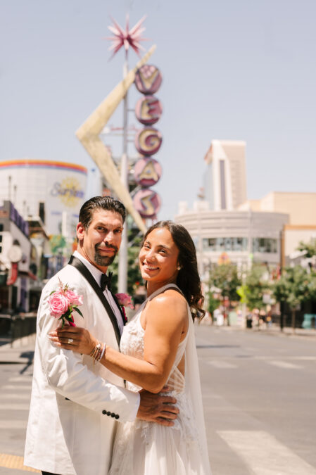 las vegas bride and groom in front of vegas sign downtown