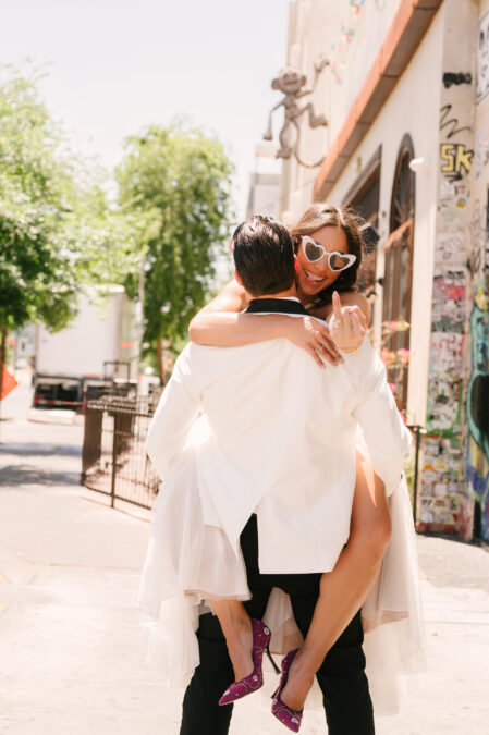 alternative las vegas downtown elopement with groom carrying his bride