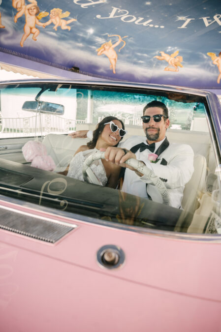 alternative bride and groom in pink cadillac 